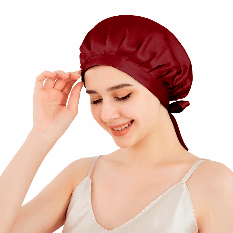 Elegant wine red silk sleep bonnet displayed on a mannequin