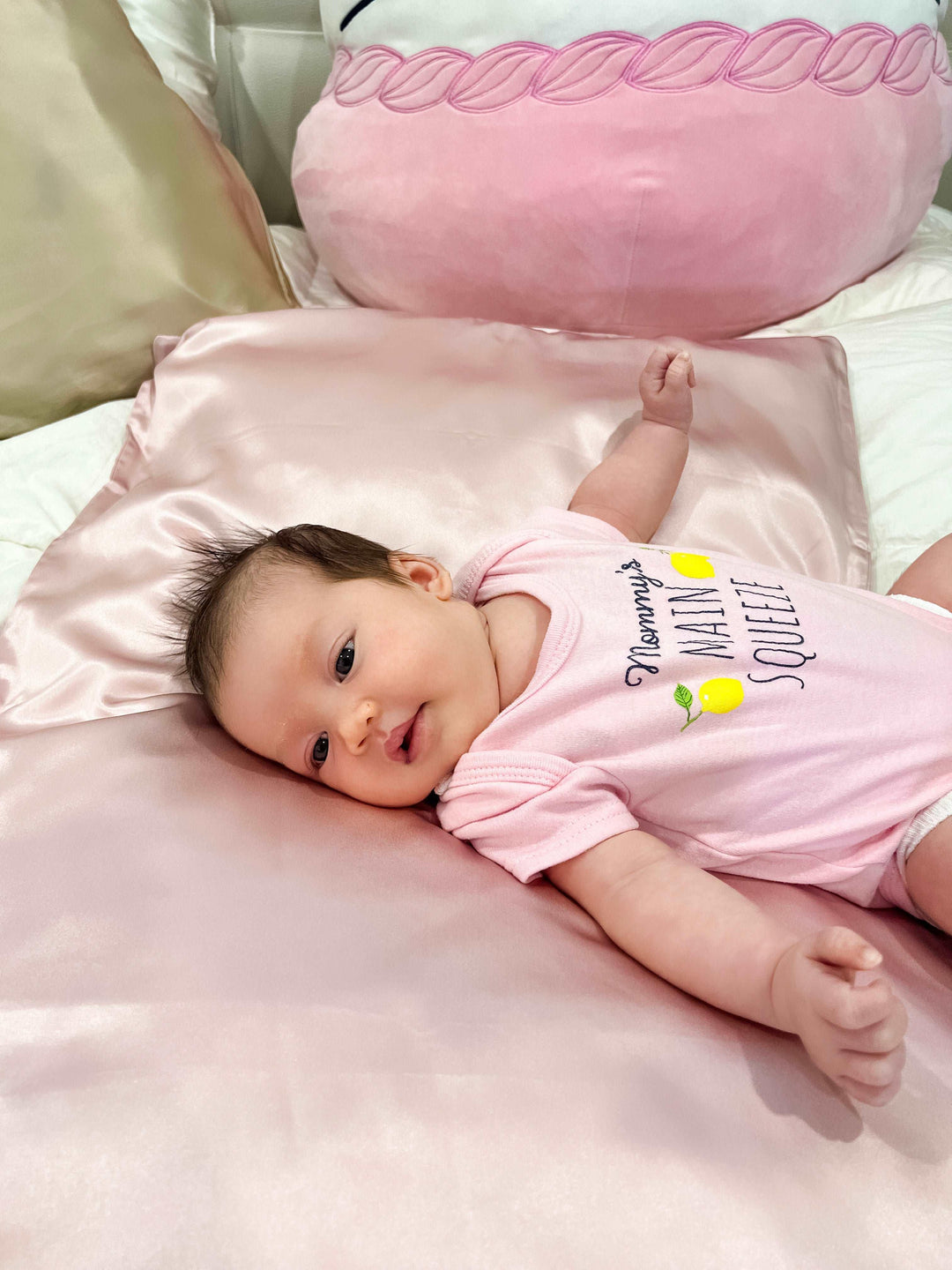 Baby Girl on a pink-themed bed with the Pink Moon Flower silk pillowcase