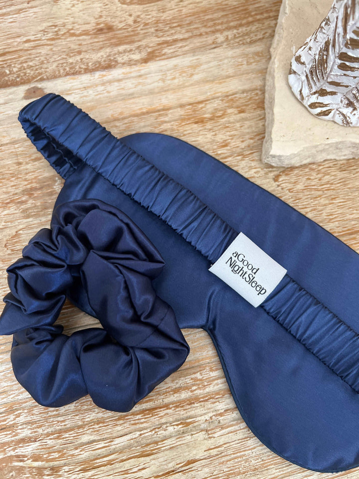 Close-up of a navy blue silk hair scrunchie
