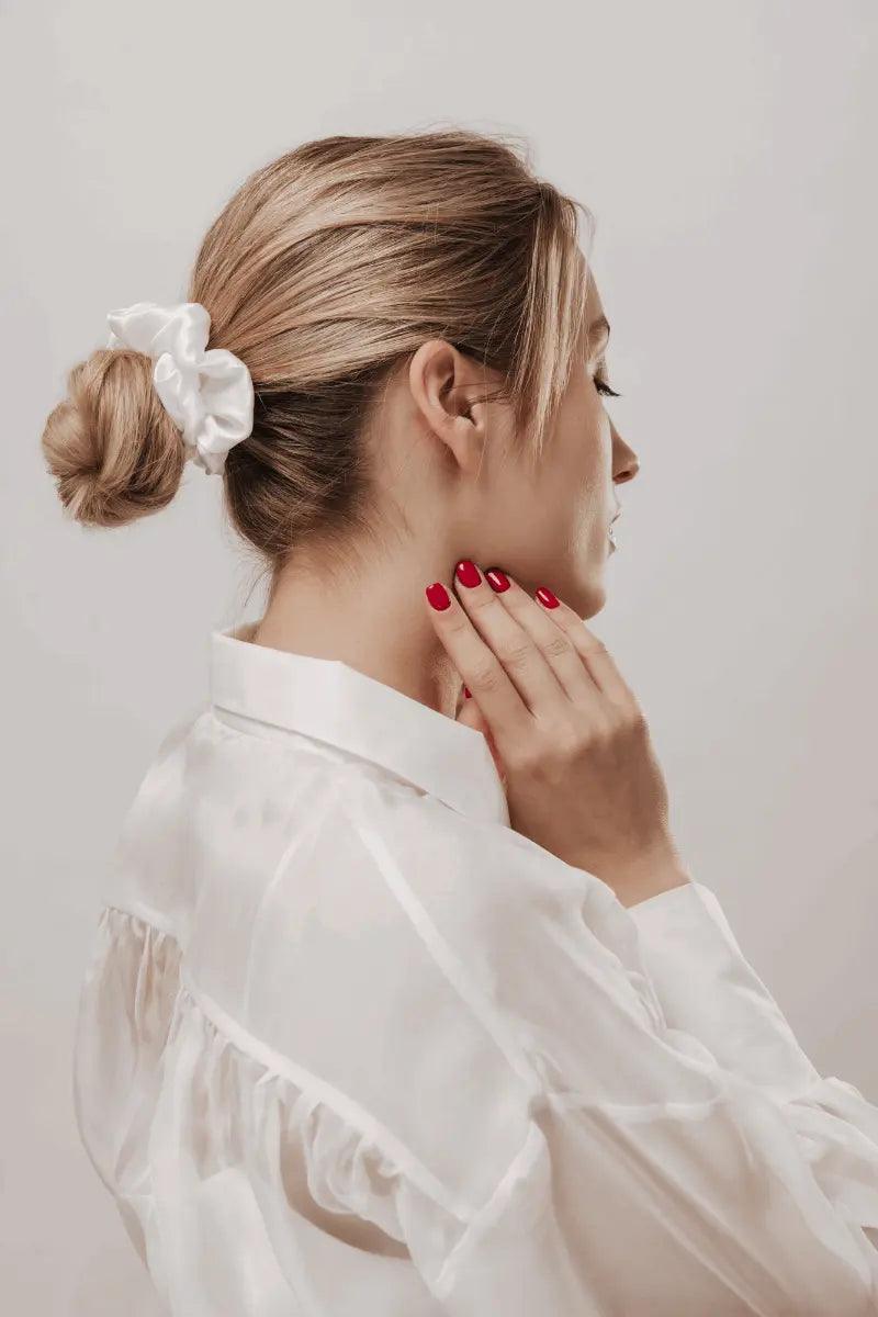 A white silk hair scrunchie Perfect for hair care and styling 