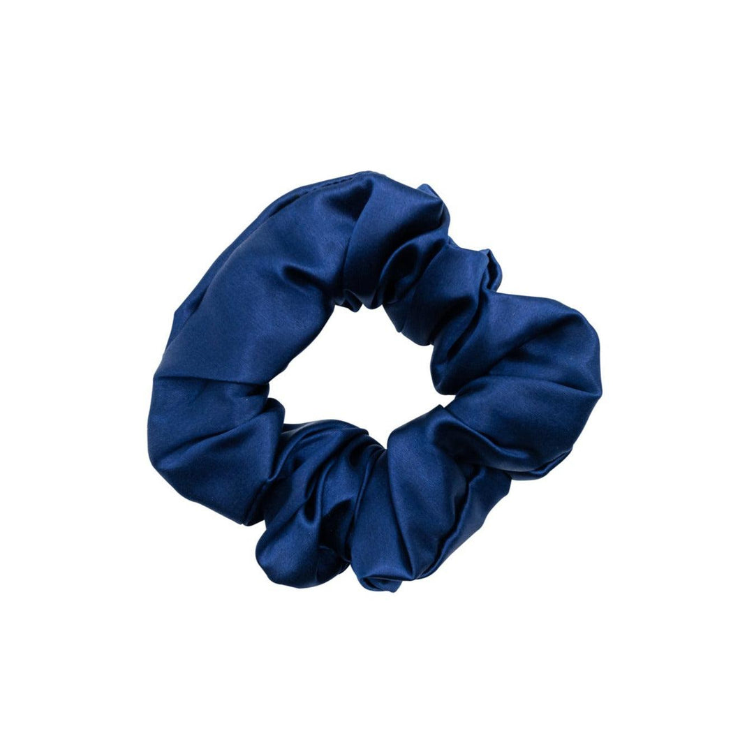 Navy blue silk hair scrunchie displayed on a white background