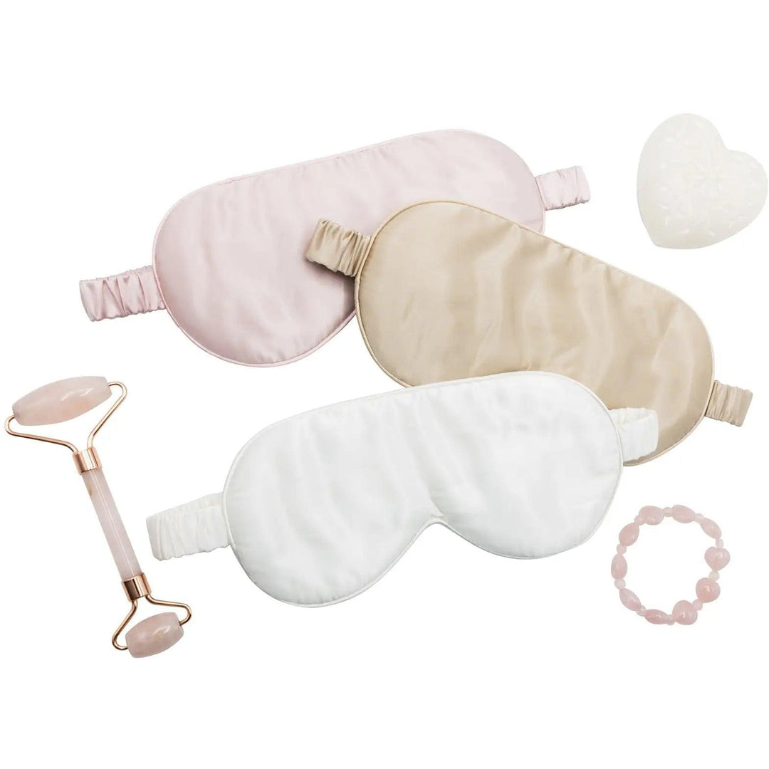 pink silk sleep mask displayed with accessories