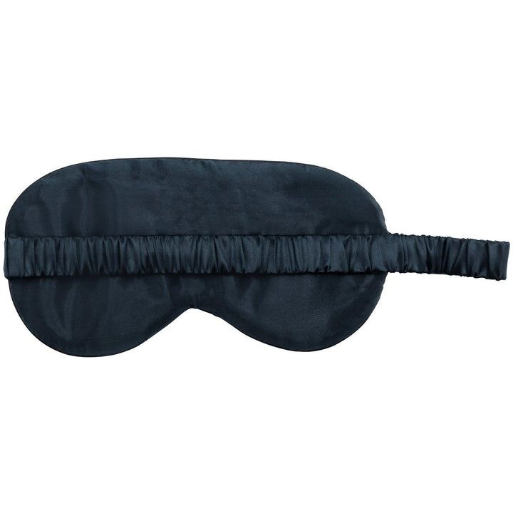 Close-up of a black silk sleep mask showing the elastic band