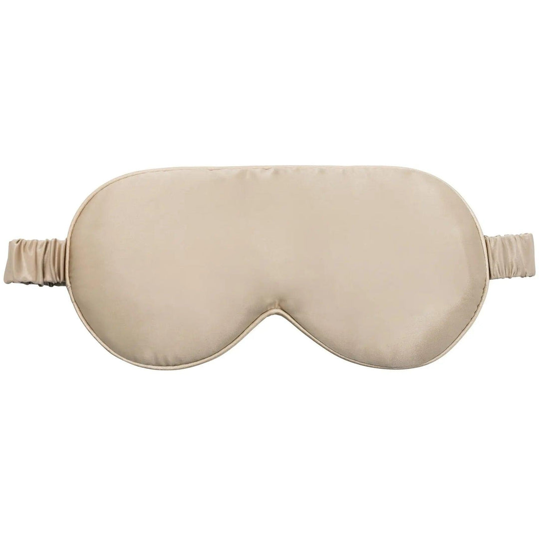 Detailed view of a champagne silk sleep mask with elastic straps