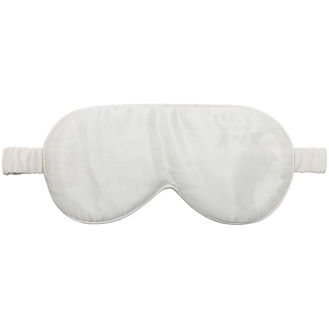 A luxurious white silk sleep mask with an elastic strap