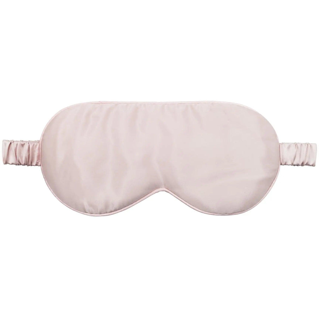 Pink silk sleep mask displayed on a pristine white background