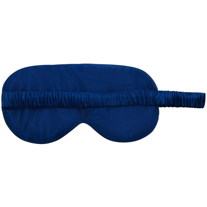 Close-up of a navy blue silk sleep mask with an adjustable band